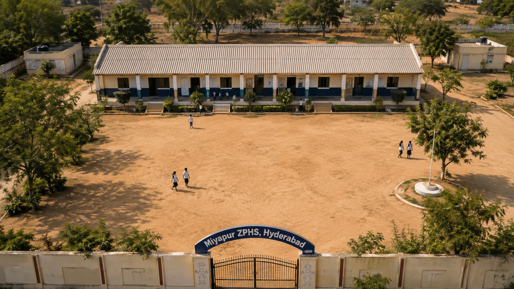 An elevated view of the Miyapur Zilla Parishad High School campus in Hyderabad: the main classroom block, open courtyard, and entrance gate.